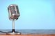 Microphone sitting on table [Image by creator olegkruglyak3 from AdobeStock]