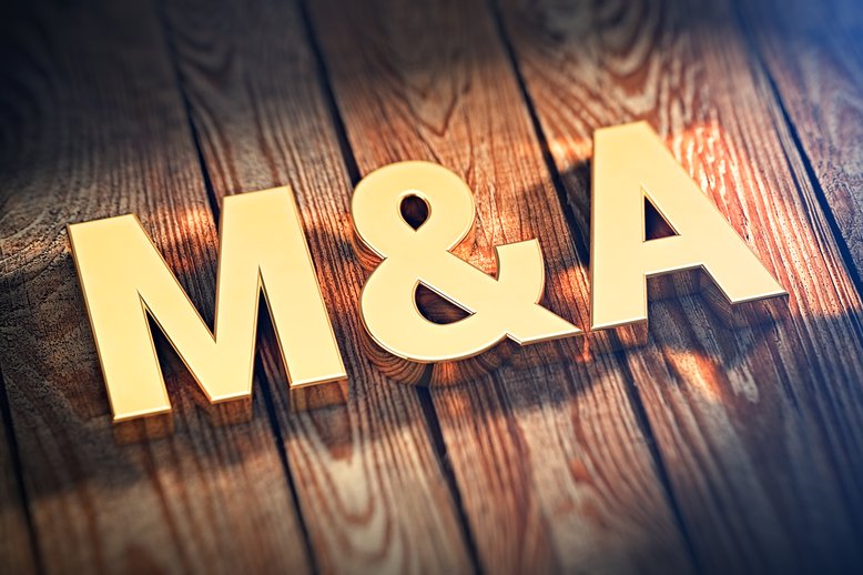 Fat gold letters "M & A" sitting on a wooden background [Image by creator Tim from AdobeStock]