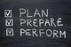 Image of a blackboard with a 3 item checklist that includes Plan, Prepare, Perform [Image by creator Yury Zap from AdobeStock]