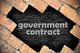Image of a brick wall with an open section that says "government contract" against a black background [Image by creator underverse from AdobeStock]