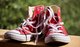a pair of unlaced red Converse basketball shoes [Image by creator sweetlouise from Pixabay]