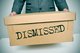 Man in a suit holding a large cardboard box that says "Dismissed" [Image by creator nito from AdobeStock]